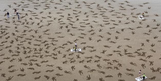 Bodies drawn on Normandy beach to commemorate D-Day deaths on International Peace Day